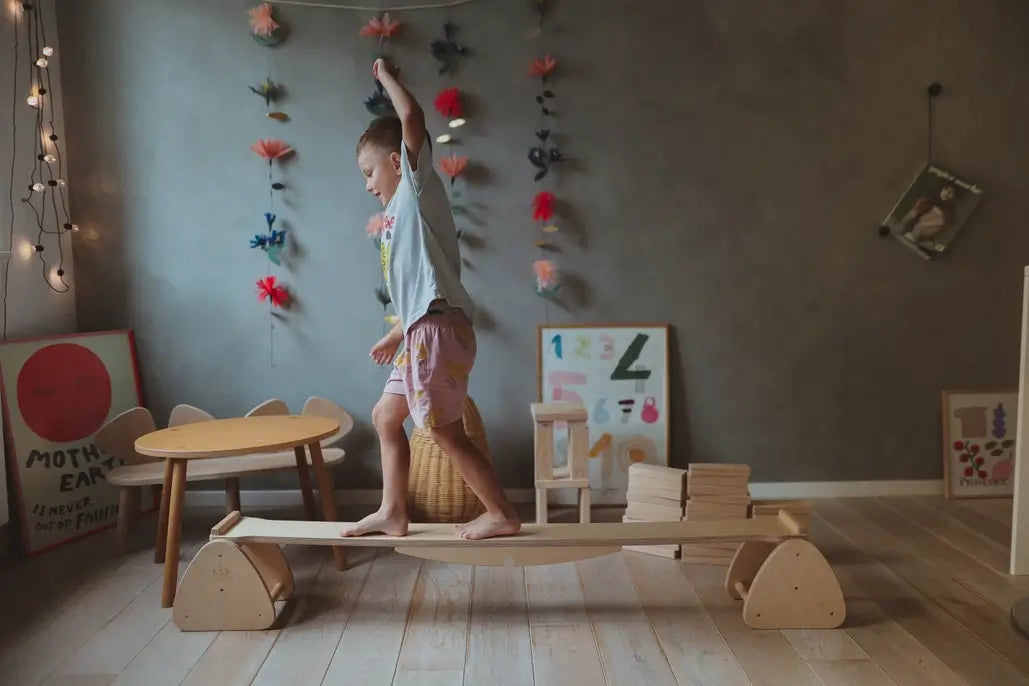 A child moves down the Pikler Balance Beam & Seesaw.