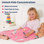 A child smiles while leaning back on a bed underneath the Kitties Weighted Cooling Lap Pad.