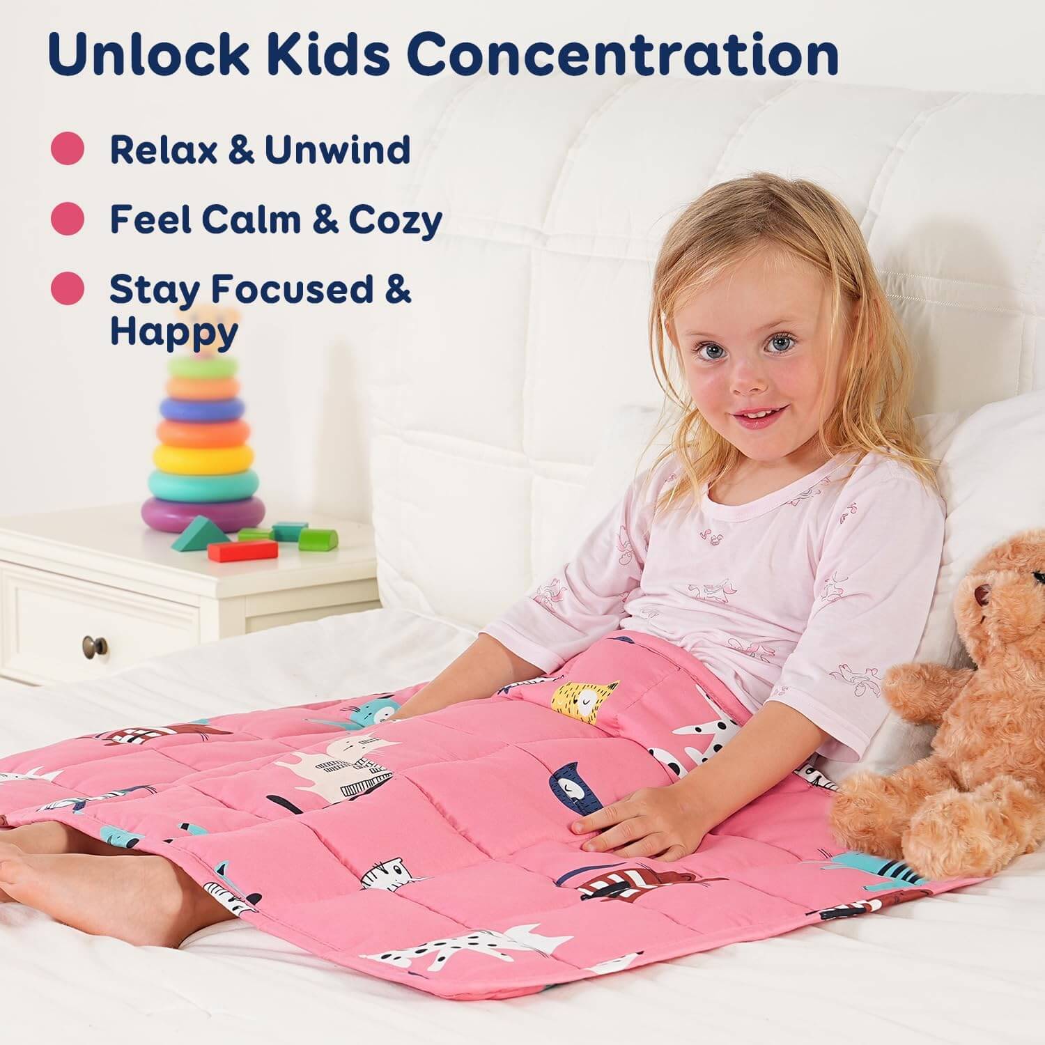 A child smiles while leaning back on a bed underneath the Kitties Weighted Cooling Lap Pad.