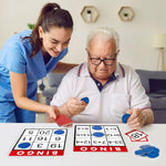 An older gentleman puts down a blue chip onto a bingo card.
