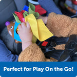 A child holds Spike the Fine Motor Hedgehog Tissue Pal while buckled into a car seat.