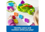 A child lines up the color and number coordinated scales of Steggy the Fine Motor Dino.