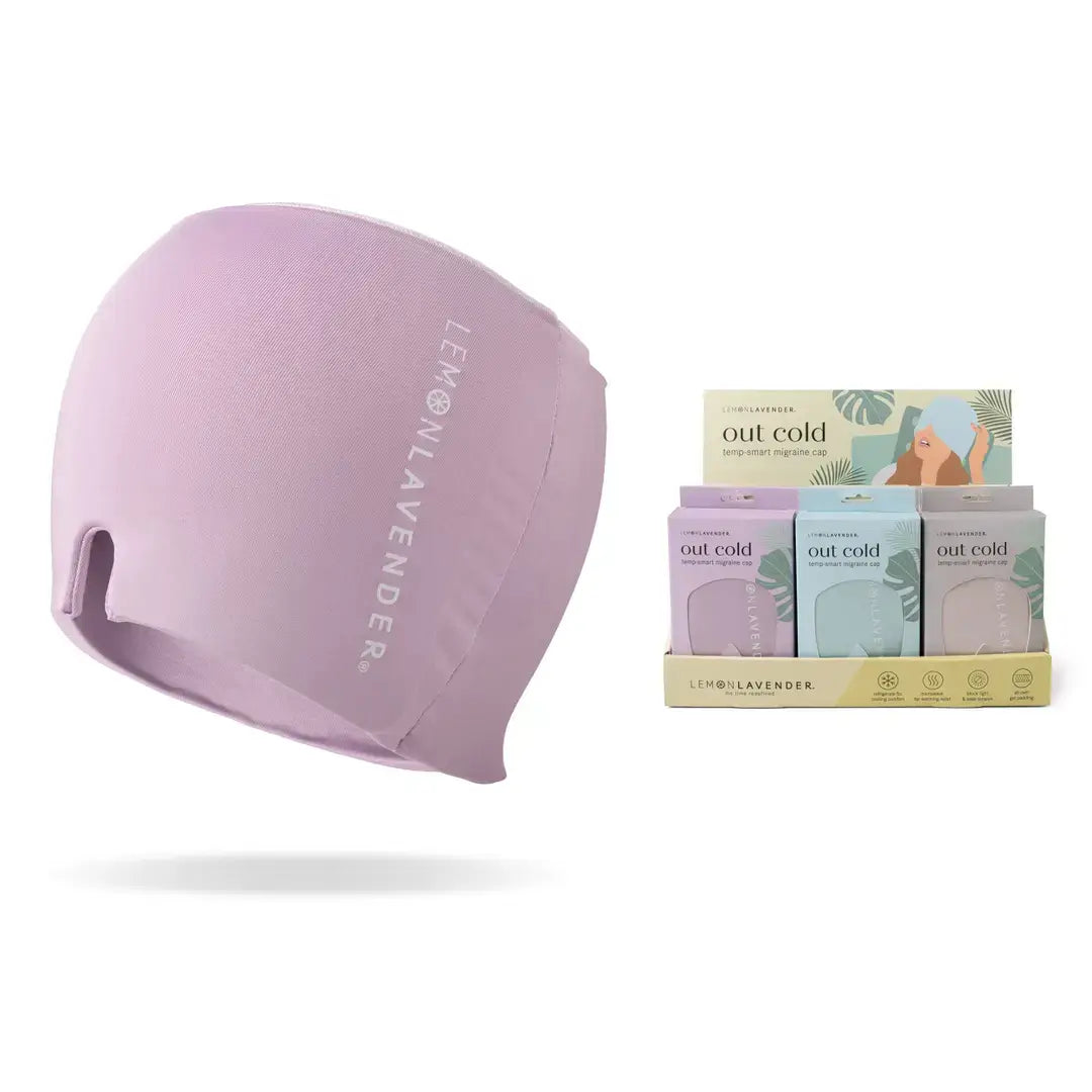 The lavender colored Out Cold Temp-Smart Migraine Cap, next to the display box of the three color variants.