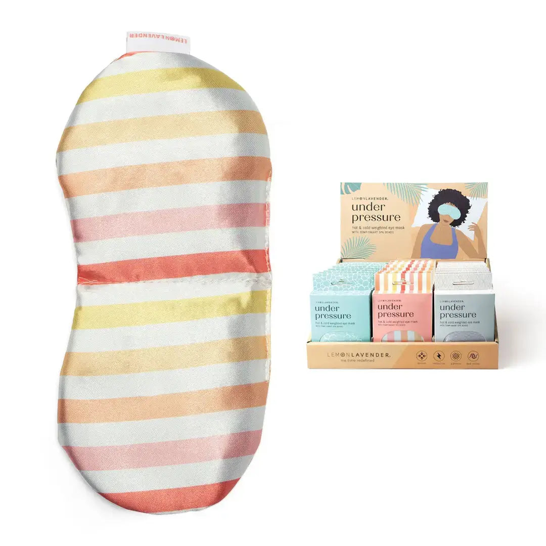 The Cabana Stripe Under Pressure Weighted Eye Mask next to the display box of three color variants.