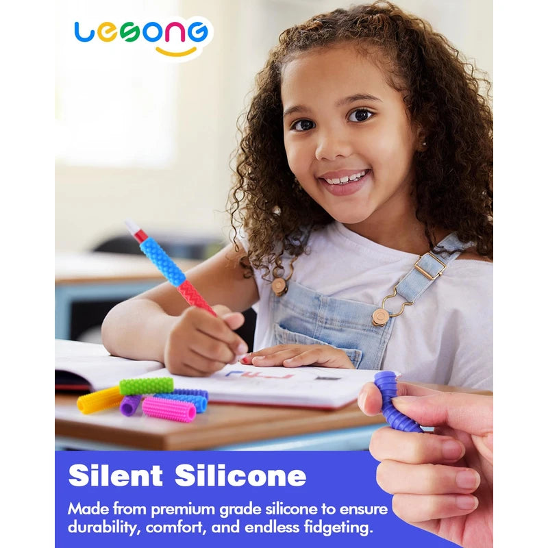 A child smiles while holding a pencil stacked with Textured Silicone Pencil Grips.
