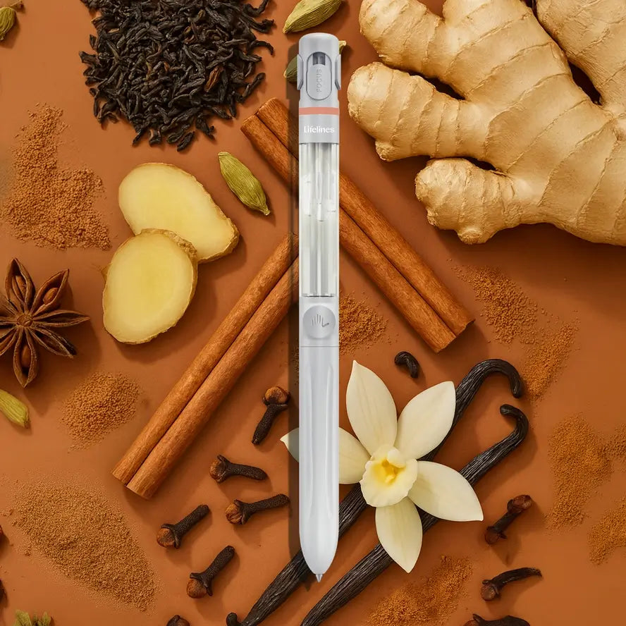 The Lifelines Spiced Chai Latte Essential Oil Pen Diffuser over a background of ginger, clove, cinnamon sticks, cardamom, star anise, and vanilla bean.