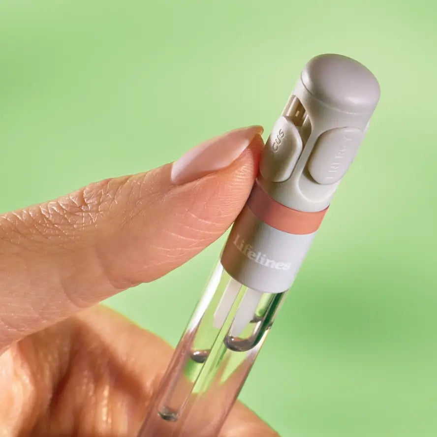 Someone uses their thumb to push down one of the vents on the Diffuser Pen.