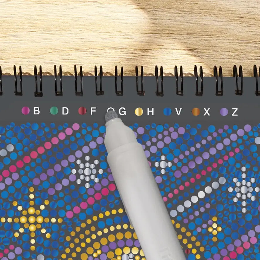 A silver marker is perched on the color key for the Lifelines FlowArt Dot-by-Letter activity pad.