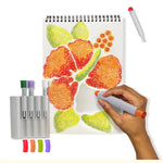 A hand fills in a petal on the Lifelines FlowArt Pogo-Dot Nature activity pad.