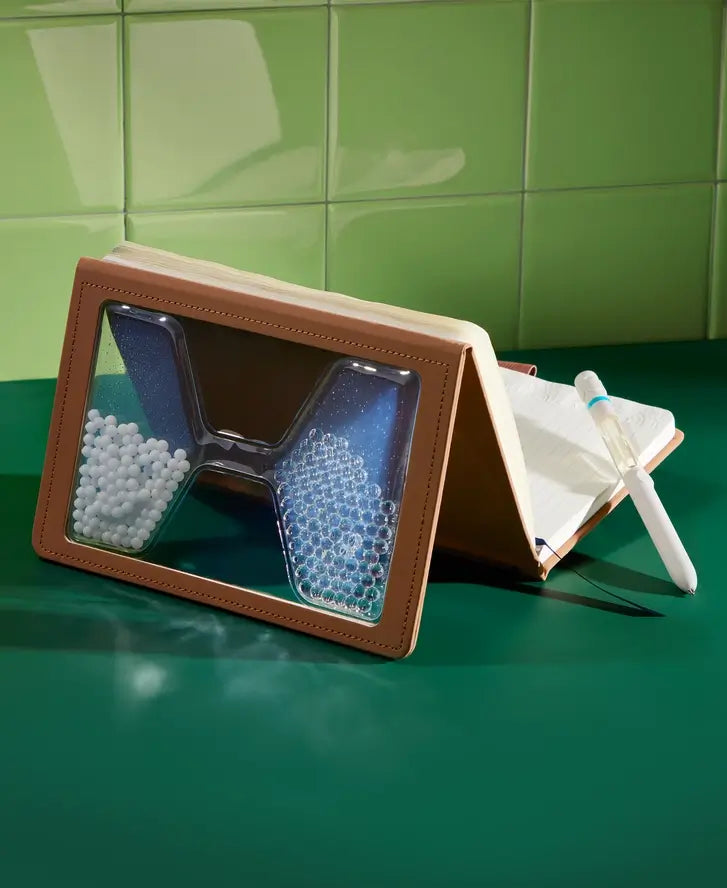 The "Take Your Time" Tactile Sensory Journal is posed on a tabletop as a fidget.