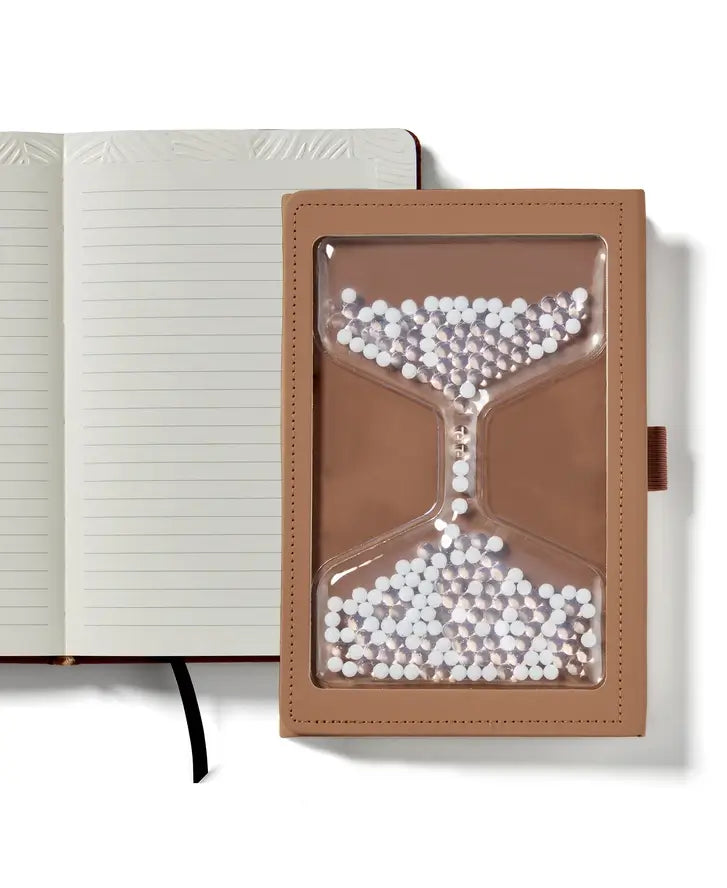 The cover of the "Take Your Time" Tactile Sensory Journal in front of an embossed page.