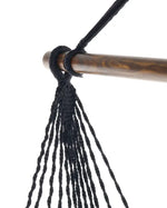 An up-close look at the pinewood spreader bar and the macrame on the Black Boho Hammock Chair Swing.