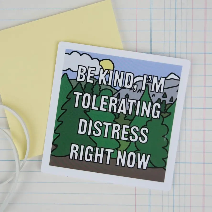The "Be Kind, I'm Tolerating Distress Right Now" 3" Vinyl Sticker placed on sticky notes.