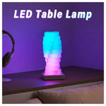 The Magic LED Cube Desk Lamp is lit up in a pink to blue ombre.