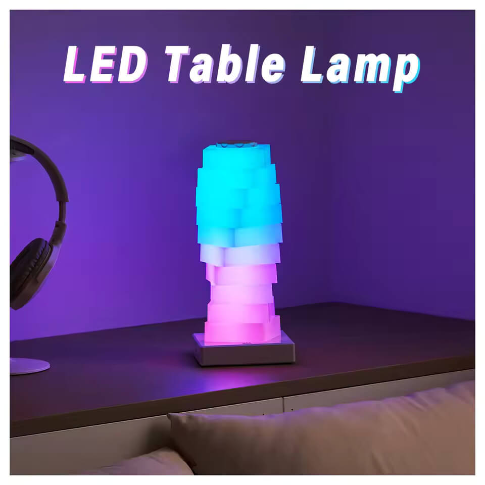 The Magic LED Cube Desk Lamp is lit up in a pink to blue ombre.