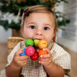 A child teeths on the Magica Grasping and Teething Toy by HABA.