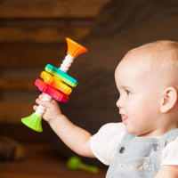 A baby holds the MiniSpinny.