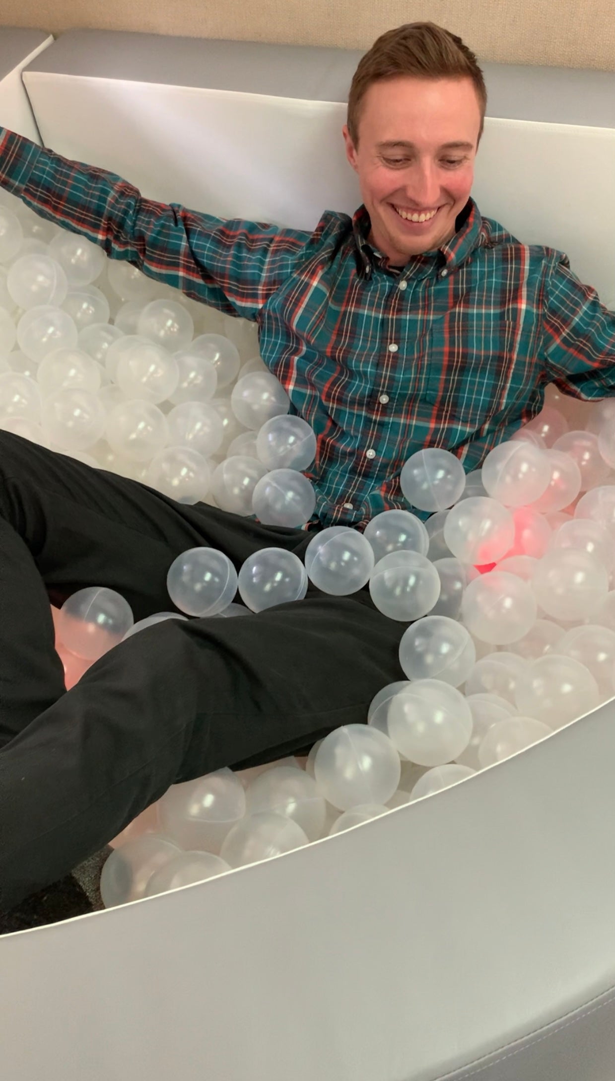 Man sitting in vibroacoustic ball pit