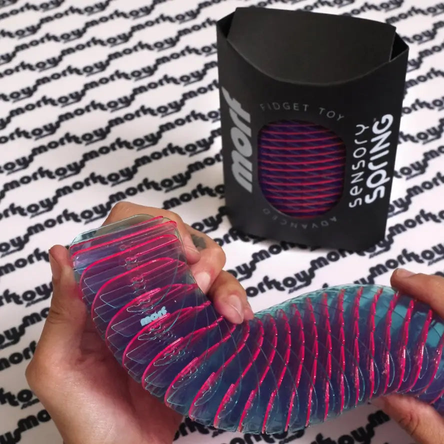 Two hands shape a snake with the Berry Morf Sensory Spring.