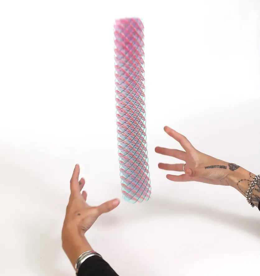 Two hands shoot the Berry Morf Sensory Spring up into the air.