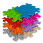 A pile of the mats that come with the Medium 1 Sensory Playmat Set.