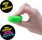 A hand squishes a green baseball Teenie Nee Doh Hot Shot.