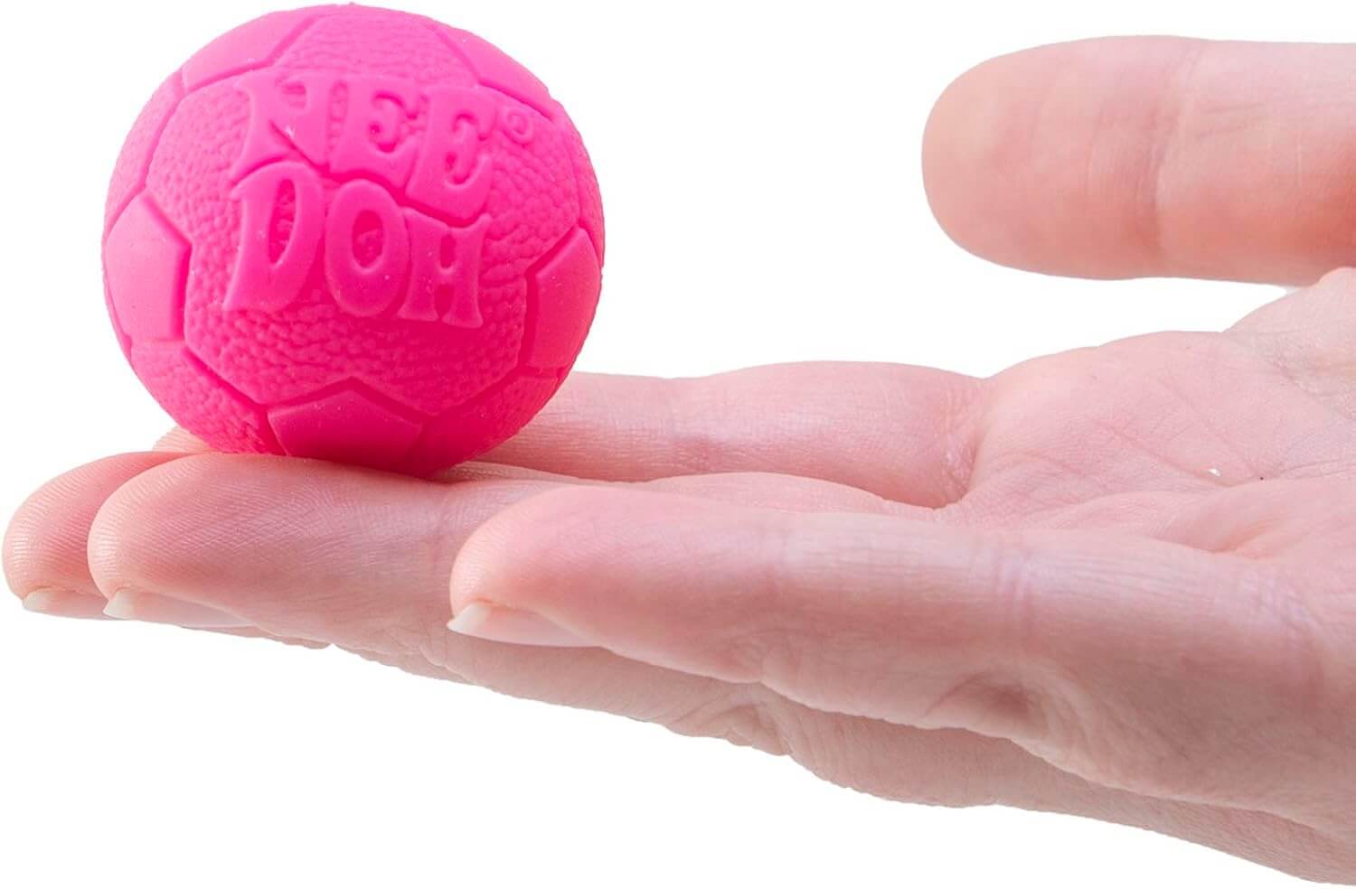 A hand holds up a hot pink soccer ball from the Teenie Nee Doh Hot Shots.