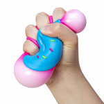 A hand squishes the blue NeeDoh Dohnut.