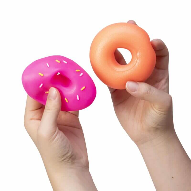 A hand demonstrates the separation of the pink frosting from the squishy Dohnut.