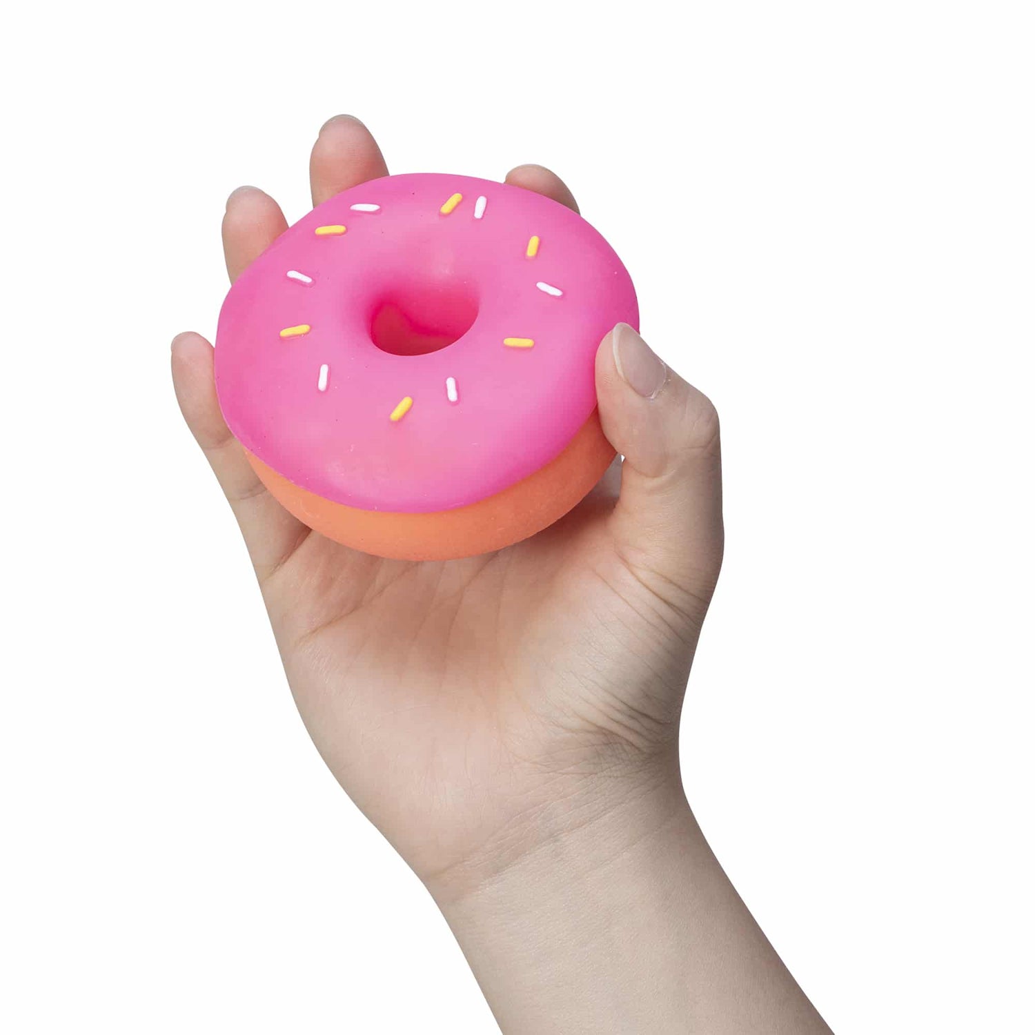 A hand holds the pink NeeDoh Dohnut.