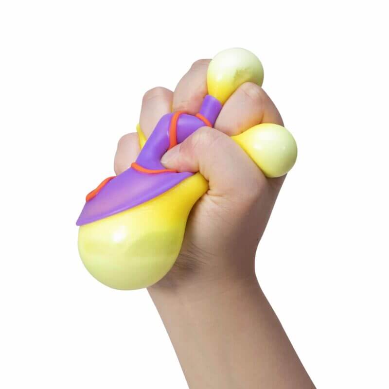 A hand squishes the purple NeeDoh Dohnut.