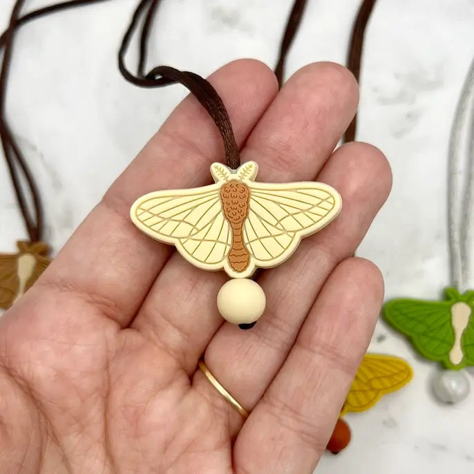 The Off-white chewy Moth Fidget Necklace.
