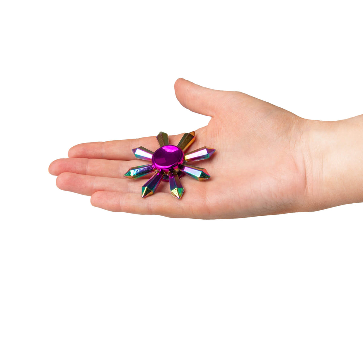 A hand holds the Fidgix Spinner in its palm.