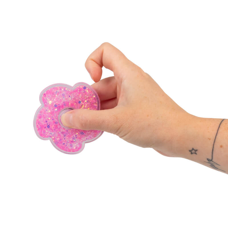 A hand holds a pink Liquid Glitter Fidget Spinner.