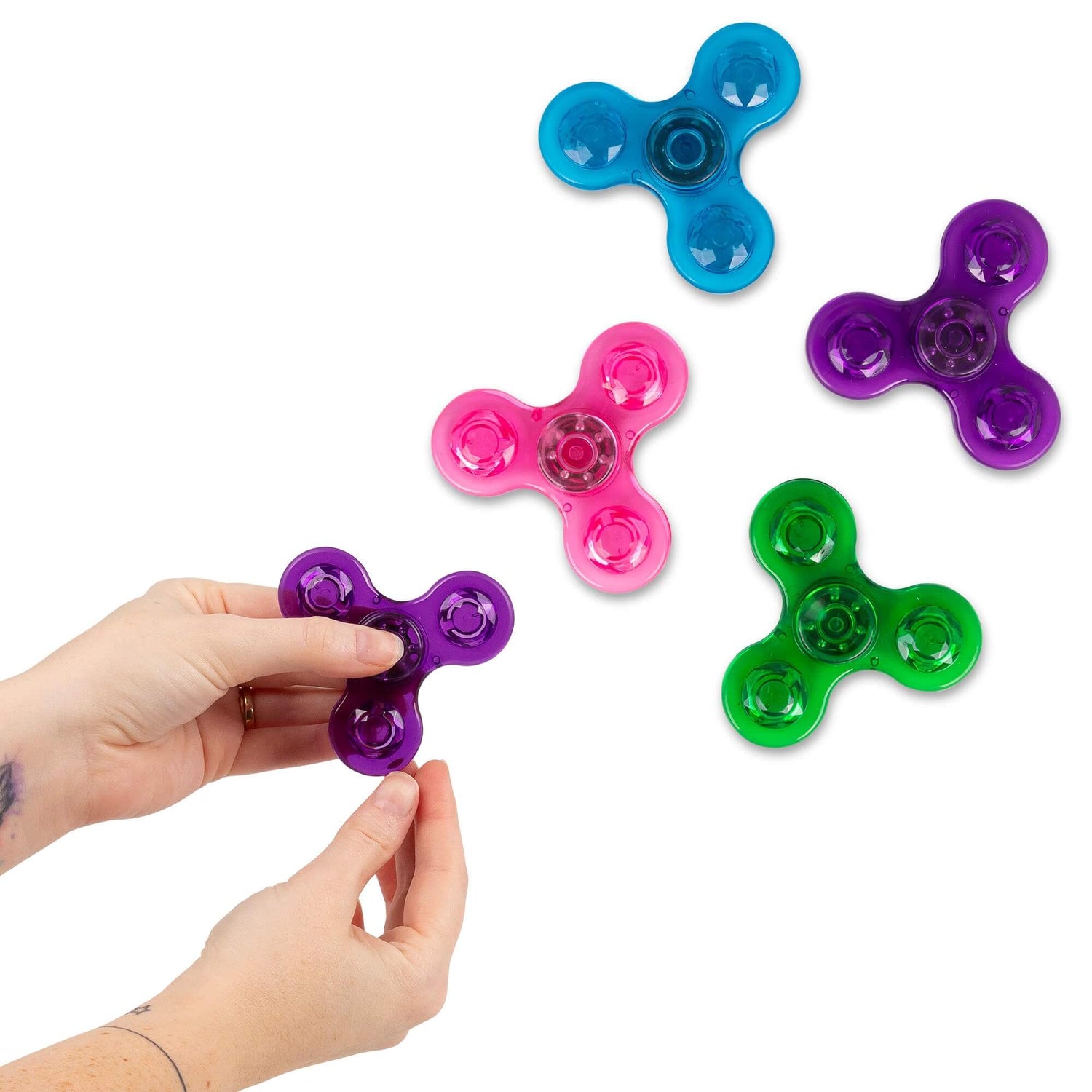 Two hands hold the purple Neon Fidget Spinner in front of the other colors.