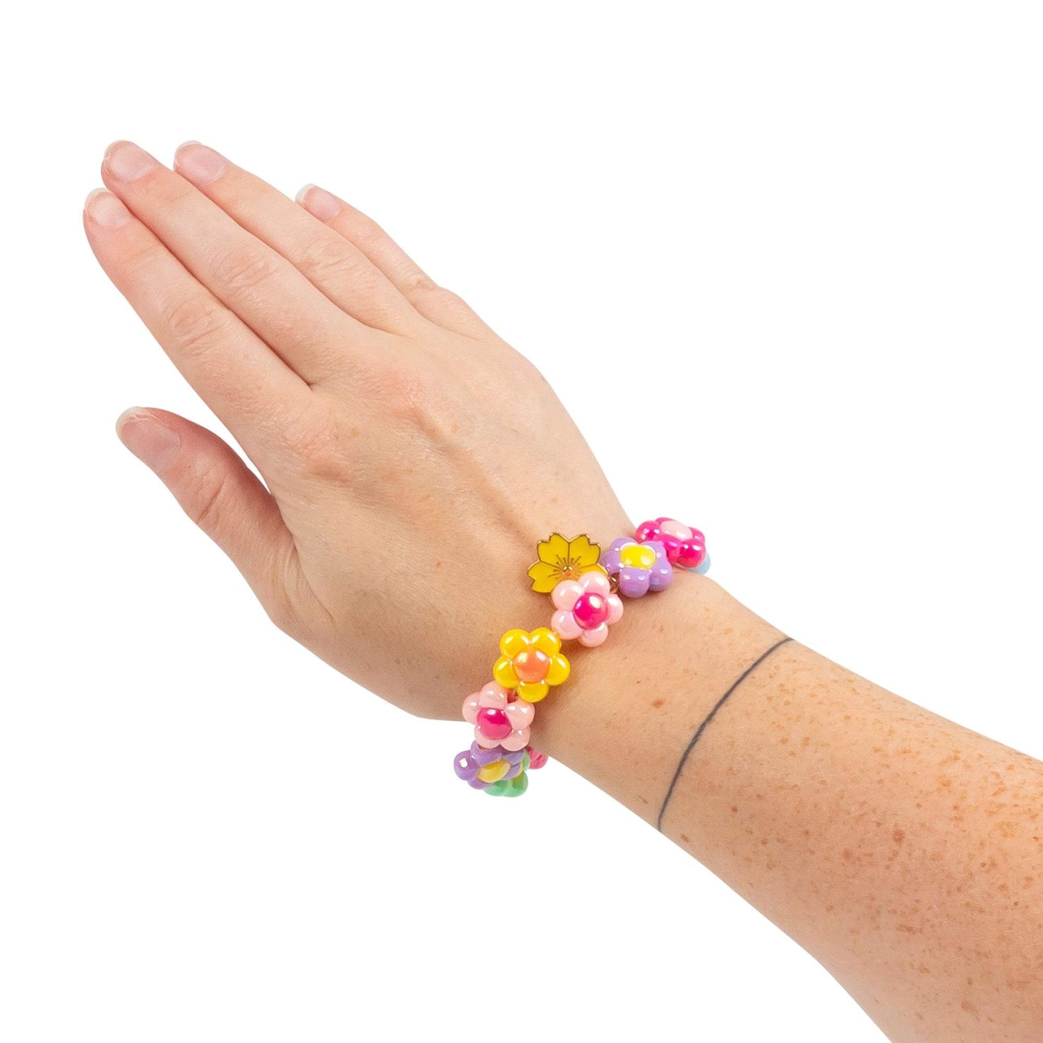 A hand wearing the Pick N Pop Bracelet - Pretty Flower Edition.