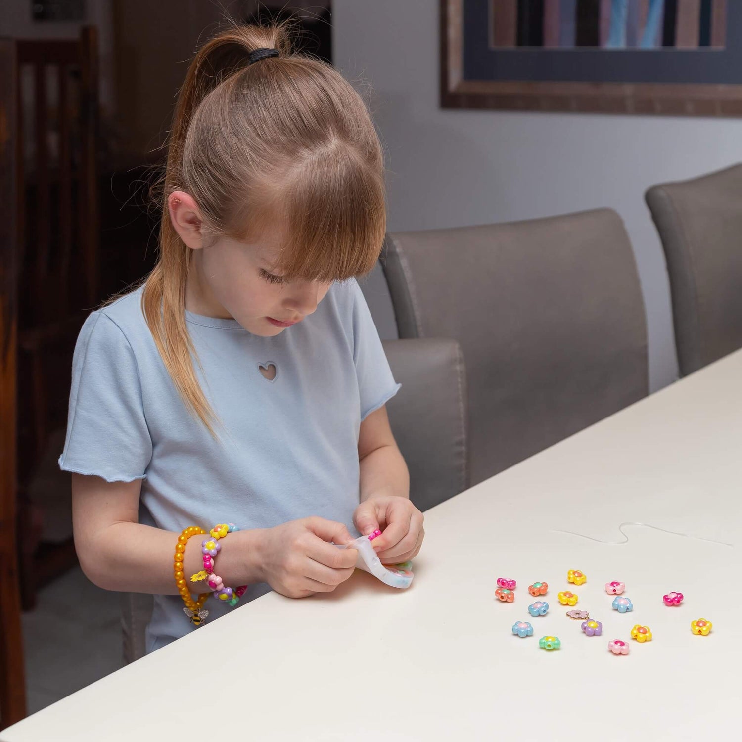 A child picks out the beads from the Pick N Pop Bracelet - Pretty Flower Edition.