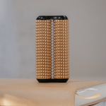 The Peach ONO Aluminum Acupressure Roller stands on a beige book.
