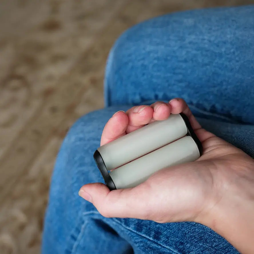 A hand holds the Ono Roller Glow-in-the-Dark junior size while it is not glowing.