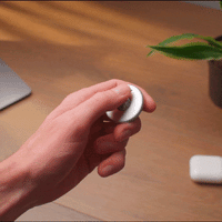 A hand moves the ball in the middle of the ONO Scroller like it is a cellphone.