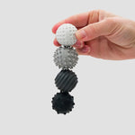 A hand holds the ONO Roller Signets - Graphite in four successive shades.
