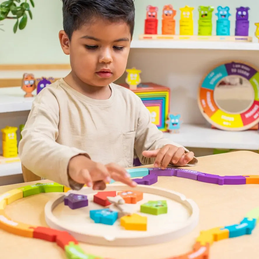 A child plays with the pieces of the My Emotions Wheel Puzzle.