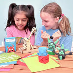 Two children play with the flash cards and the clay that come in the Anger Management in a Box Tool Kit.