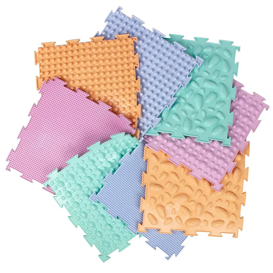 The 8 pastel mats that come in the Ortodon Puzzle Mat set arranged in a neat pinwheel.