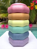 The Pastel Rainbow Stepping Stone Set with 6 Pieces, stacked on a diving board.