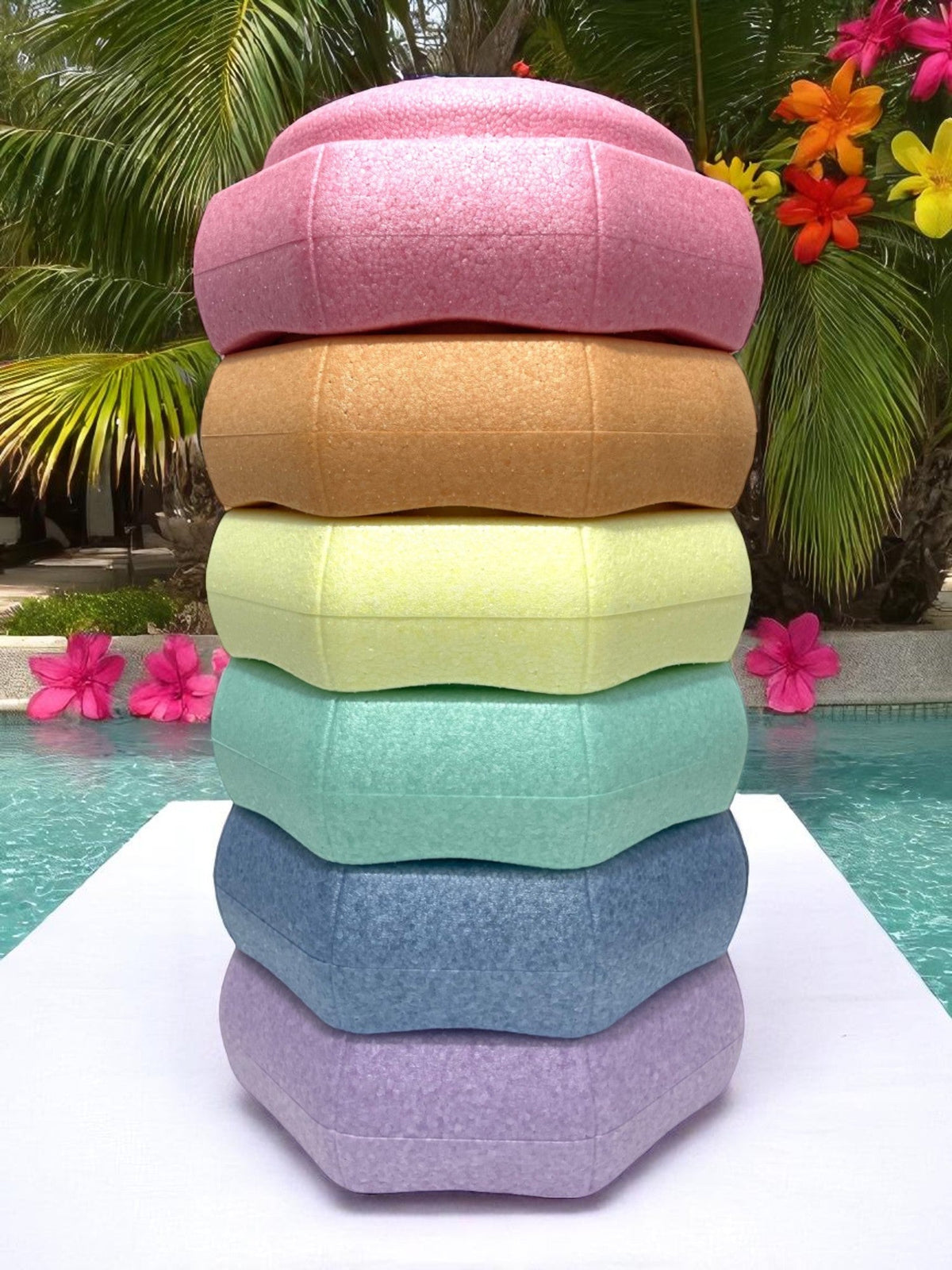 The Pastel Rainbow Stepping Stone Set with 6 Pieces, stacked on a diving board.
