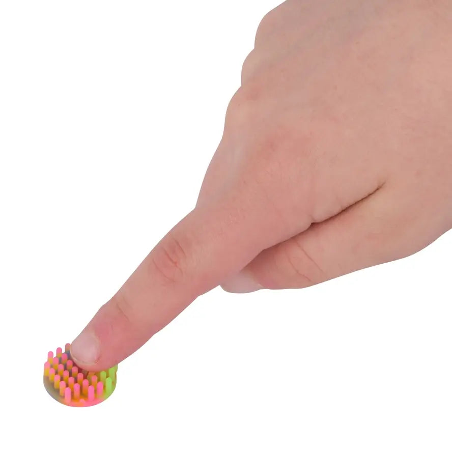 A finger presses a small Silicone Zen Mini Dot.