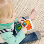 A toddler pushes the buttons on the Switch Tile.