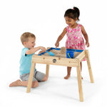 Two children play with sand in the Build and Splash Wooden and and Water Table.
