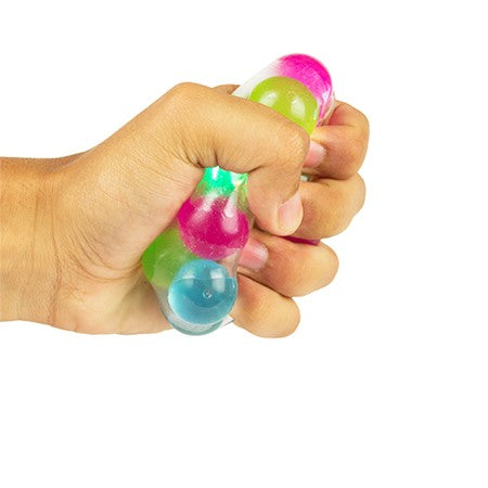 A hand with light skin tone squeezes the Light-Up Molecule Stress Ball.